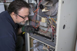 technician-looking-over-gas-furnace